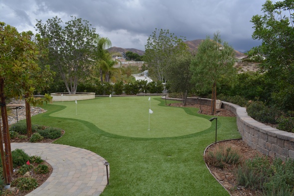 Fresno Synthetic grass golf green in a landscaped backyard