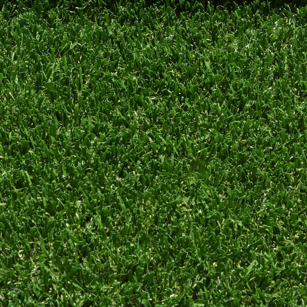 A close up shot of artificial turf designed for playgrounds featuring short green grass strands