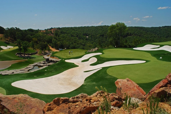 Fresno lush green synthetic grass golf course with white sand bunkers and blue sky